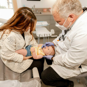 Dr. Birch takes care of the baby's oral at Eleven Eleven Dental